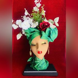 She’s a handmade Afrocentric floral arrangement for decoration.